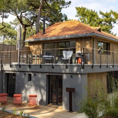 Maison bois avec des baies vitrées et fenêtres en aluminium.